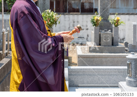 A monk recites in front of the Perpetual Memorial Cemetery 106105133