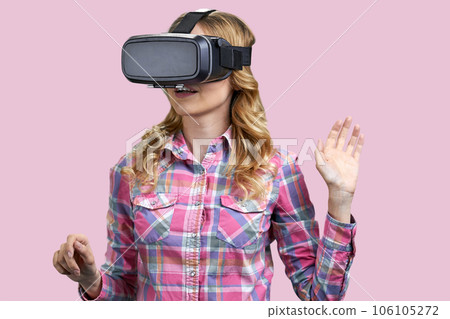 Portrait of young blonde experiencing virtual reality simulation. Isolated on pink. Portrait of young blonde experiencing virtual reality simulation. Isolated on pink. 106105272