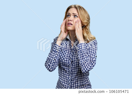 Portrait of stressed and despareted young blond woman. Touching cheeks with both hands. Oh no I forgot something. 106105471