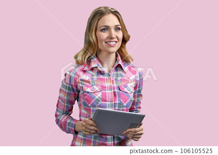 Portrait of happy young blonde woman with tablet pc. Isolated on pink background. Portrait of happy young blonde woman with tablet pc. Isolated on pink background. 106105525
