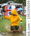 Have fun and learn English. Child in waterproof coat is jumping in the puddle with British flag in hand. Jump into English language. Pretty funny little cute kid having fun. Child playing. 106105699