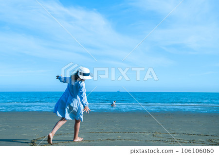 Child running with hands lke a plane. Kid flying. Little girl playing with toy airplane on sea shore. Family summer vacation on exotic island. Water and sand fun for kids 106106060