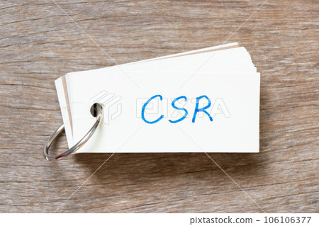Flash card with handwriting in word CSR (Abbreviation of corporate social responsibility) on wood background 106106377