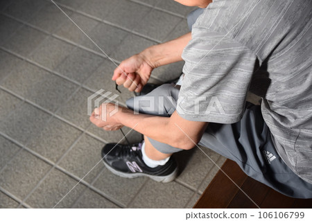 Elderly people tying shoelaces Elderly people tying shoelaces 106106799