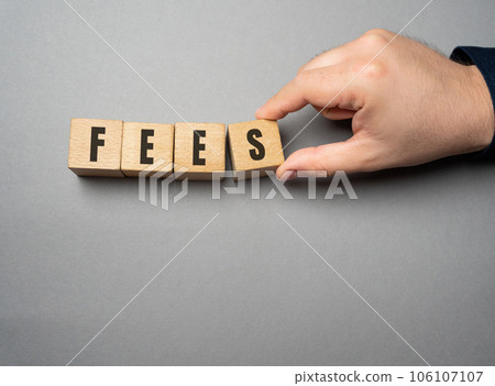 Fees word concept. Fixed price charged for a specific service. Business and finance concept. Costs, charges, commissions, penalties. Cost, fee and taxes. Wooden blocks Fees word concept. Fixed price charged for a specific service. Business and finance concept. Costs, charges, commissions, penalties. Cost, fee and taxes. Wooden blocks 106107107