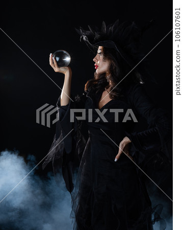 Witch sorceress with crystal ball 106107601
