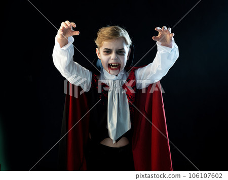 Boy wearing Halloween vampire costume Boy wearing Halloween vampire costume 106107602
