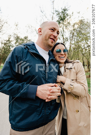 Happy romantic couple enjoying a walk in the park Happy romantic couple enjoying a walk in the park 106107677