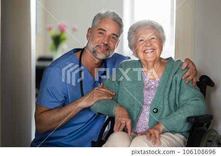 Portrait of caregiver with patient, senior woman in her home. 106108696