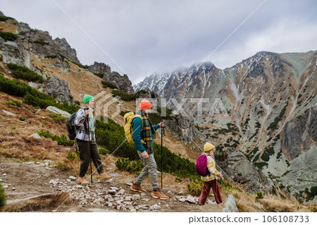 Happy family hiking together in autumn mountains. 106108733