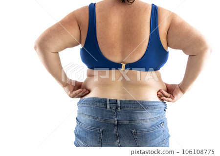 Plus size overweight woman holds her hips full of fat - Isolated on white 106108775