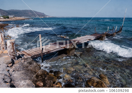 Crete's Coastal Heritage: Aged Pier and Waves Malia Beach - Crete - July - 2023 106109298