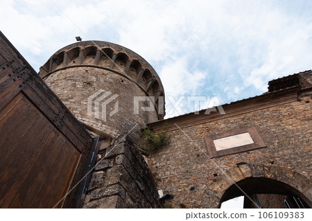 Ancient observation tower of a town in the Tuscan hills with cloudy sky in the background Ancient observation tower of a town in the Tuscan hills with cloudy sky in the background 106109383