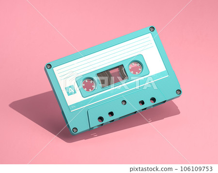 Blue vintage audio cassette on pink background. 106109753