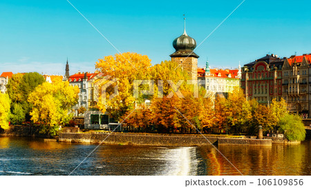 Ancient tower on the river bank in the fall. Autumn Prague. Landscape. Ancient tower on the river bank in the fall. Autumn Prague. Landscape. 106109856