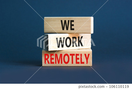 We work remotely symbol. Concept words We work remotely on wooden block. Beautiful grey table grey background. Business we work remotely concept. Copy space. 106110119