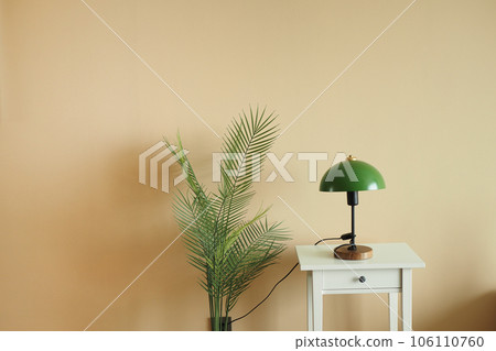 a table lamp in home against light orange wall  106110760