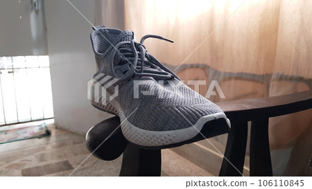 closeup view of a single grey fashionable sneaker shoe. gray sports casual shoes 106110845