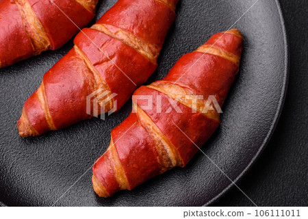 Delicious sweet crunchy red croissant with cream filling 106111011