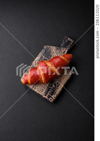 Delicious sweet crunchy red croissant with cream filling 106111020