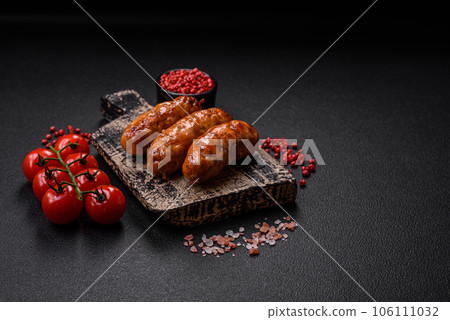 Delicious juicy grilled sausages with salt, spices and herbs 106111032