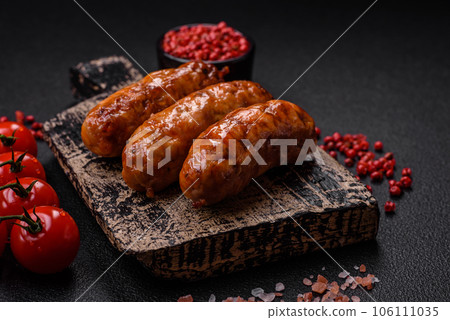 Delicious juicy grilled sausages with salt, spices and herbs 106111035