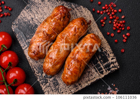 Delicious juicy grilled sausages with salt, spices and herbs Delicious juicy grilled sausages with salt, spices and herbs 106111036