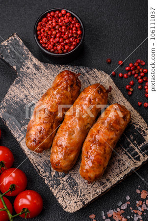 Delicious juicy grilled sausages with salt, spices and herbs Delicious juicy grilled sausages with salt, spices and herbs 106111037