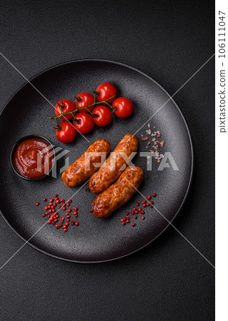 Delicious juicy grilled sausages with salt, spices and herbs 106111047
