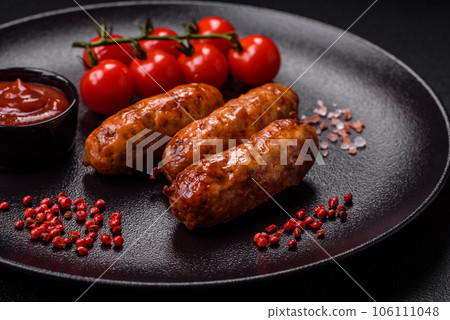 Delicious juicy grilled sausages with salt, spices and herbs Delicious juicy grilled sausages with salt, spices and herbs 106111048