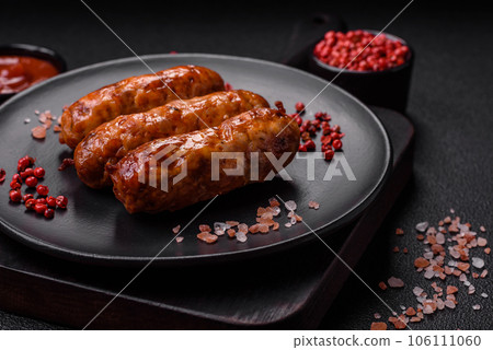 Delicious juicy grilled sausages with salt, spices and herbs Delicious juicy grilled sausages with salt, spices and herbs 106111060
