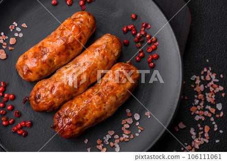 Delicious juicy grilled sausages with salt, spices and herbs Delicious juicy grilled sausages with salt, spices and herbs 106111061