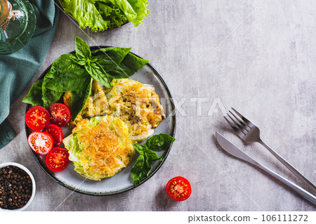 Young cabbage steaks, tomatoes and basil on a plate top view Young cabbage steaks, tomatoes and basil on a plate top view 106111272
