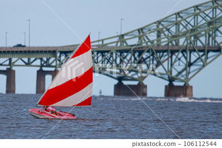 Sunfish sailboat sailing by the Great South Bay Bridge Sunfish sailboat sailing by the Great South Bay Bridge 106112544