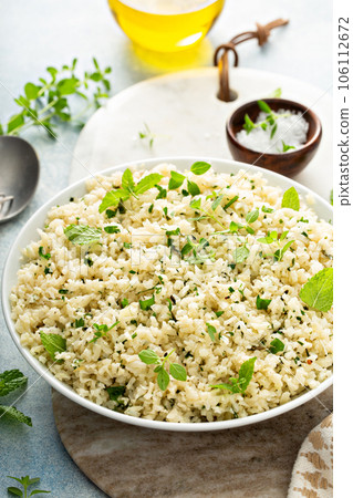 Cauliflower rice with herbs and lemon juice in a white bowl Cauliflower rice with herbs and lemon juice in a white bowl 106112672