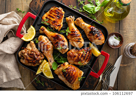 Grilled chicken thighs and drumsticks with honey glaze Grilled chicken thighs and drumsticks with honey glaze 106112697