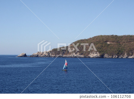 Sail boat drifts out of the harbor in Zihuatanejo Sail boat drifts out of the harbor in Zihuatanejo 106112708