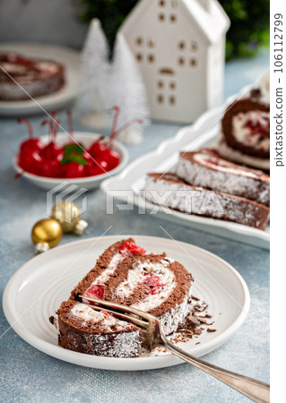Black forest cake roll with whipped cream and cherries Black forest cake roll with whipped cream and cherries 106112799