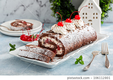 Black forest cake roll with whipped cream and cherries Black forest cake roll with whipped cream and cherries 106112801