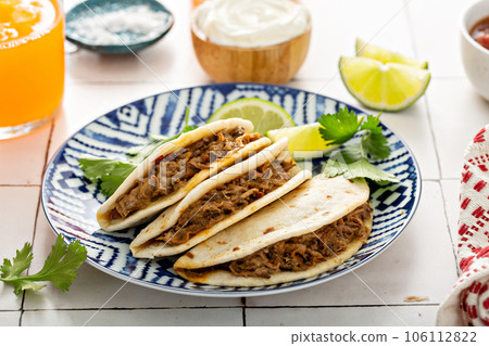 Baked tacos with Mexican Shredded Beef and cheese 106112822