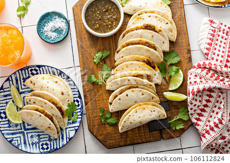 Baked tacos with Mexican Shredded Beef and cheese 106112824