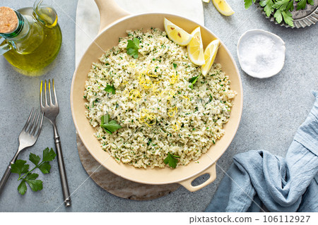 Lemon herb cauliflower rice cooked in a pan 106112927