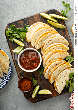 Baked tacos with pulled chicken and cheese Baked tacos with pulled chicken and cheese 106112935