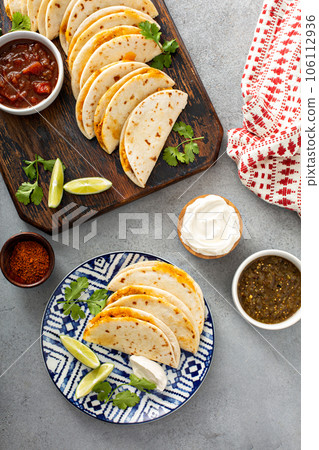 Baked tacos with pulled chicken and cheese Baked tacos with pulled chicken and cheese 106112936
