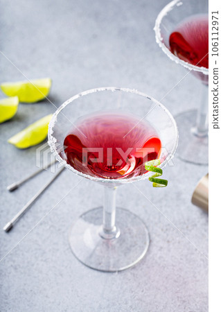 Traditional Cosmopolitan martini with sugar rim and garnish 106112971