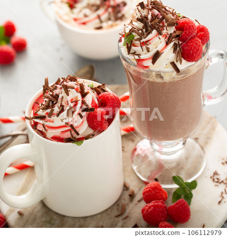 Summer hot chocolate with whipped cream and raspberry syrup 106112979