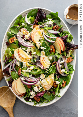 Winter salad with apple and pecans with vinaigrette dressing Winter salad with apple and pecans with vinaigrette dressing 106113105