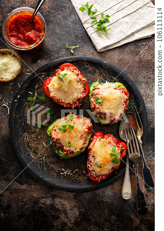 Stuffed peppers with ground beef filling on a plate 106113114