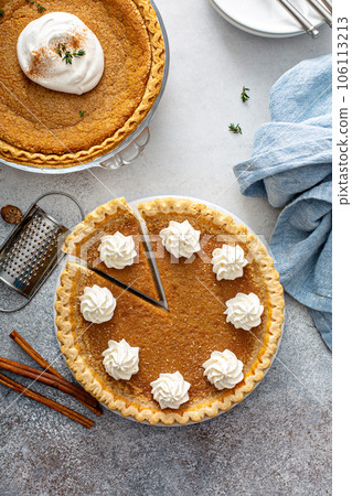 Traditional pumpkin pie with whipped cream and cinnamon 106113213