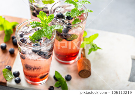 Blueberry mojito in tall glasses with mint Blueberry mojito in tall glasses with mint 106113219